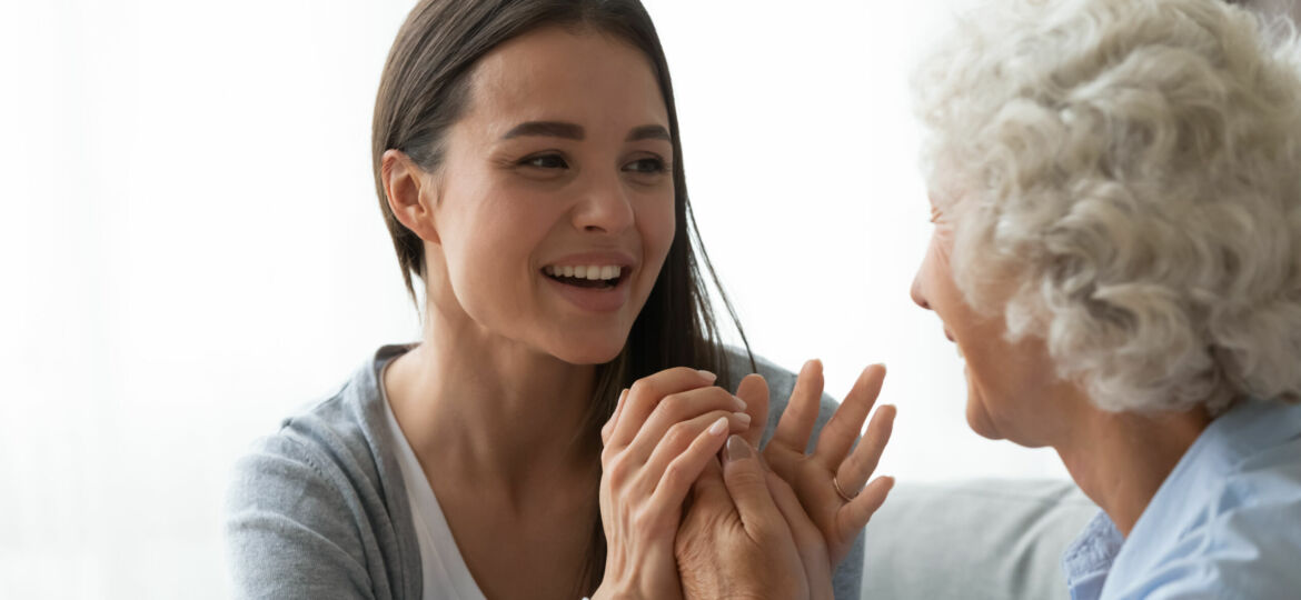 Joyful,Millennial,Pretty,Woman,Holding,Hands,Of,Smiling,Older,Retired